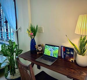 a desk with a laptop computer on top of it at Green homestay, King beds, 5min from Hue city in Thôn Trường Giang +62 photos