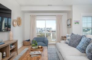 a living room with a couch and a table at SALTY DALTY & THREE BUOYS townhouse in Atlantic Beach