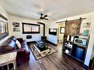 a living room with a couch and a table at The Loose Moose Cabin #11 At Downtown Grand Lake in Grand Lake