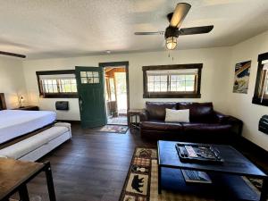 a living room with a bed and a couch at The Loose Moose Cabin #11 At Downtown Grand Lake in Grand Lake