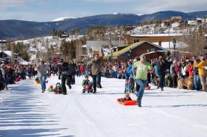 a large crowd of people walking in the snow at The Loose Moose Cabin #11 At Downtown Grand Lake in Grand Lake