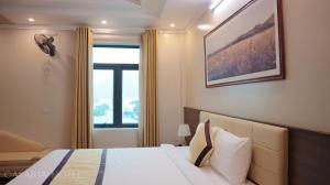 a hotel room with a bed and a window at Casaria Hotel in La Phù +74 photos