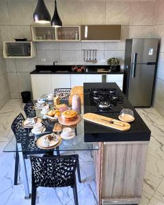 a kitchen with a table with plates of food on it at Flat Antônio in São José do Egito