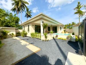 a house with a driveway and a swimming pool at Karleya residence in Nathon Bay
