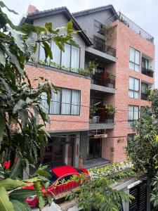 a red car parked in front of a brick building at CHAMECO ART Boutique Home Danang in Da Nang