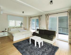 a bedroom with a bed and a couch at Garten Apartment Wurzinger in Halbenrain