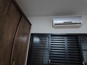 a room with a air conditioner on the wall at Pousada Canto dos pássaros in Cianorte