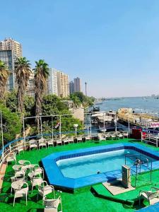 a swimming pool with chairs and the ocean in the background at الباخرة نايل كروز ريفر بوت in Cairo