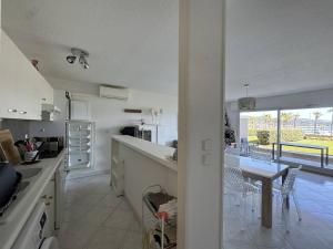 a kitchen and dining room with a view of a patio at Appartement avec grande terrasse et garage à Cavalaire-sur-Mer - FR-1-100-355 in Cavalaire-sur-Mer +6 photos