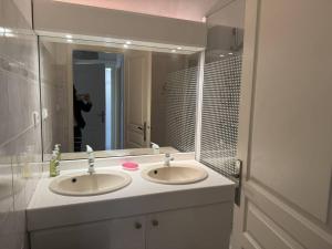 a bathroom with two sinks and a large mirror at Appartement avec grande terrasse et garage à Cavalaire-sur-Mer - FR-1-100-355 in Cavalaire-sur-Mer