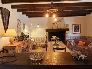 a living room with a couch and a fireplace at Gîte 8 personnes avec cheminée et SPA à Biron - FR-1-616-481 in Biron