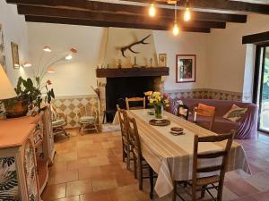 a dining room with a table and a fireplace at Gîte 8 personnes avec cheminée et SPA à Biron - FR-1-616-481 in Biron