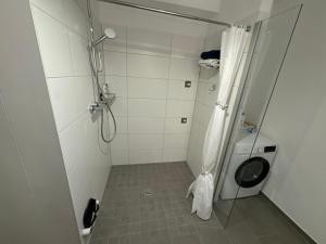 a bathroom with a shower and a toilet at Neue Wohnungen im Jahr 2023 in Emmerich