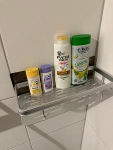a shelf in a bathroom with four bottles of paint at Neue Wohnungen im Jahr 2023 in Emmerich