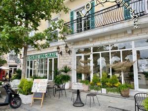 a cafe with tables and chairs in front of a building at Lotus Home Cafe - Cable Car Station in Phú Quốc +51 photos
