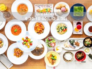a table with plates of food on it at Mitsui Garden Hotel Sendai - Reopening on June 14 in Sendai