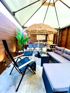 a living room with a couch and a table at 海宿ニシノヤ in Shioya