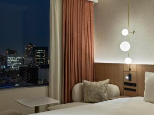 a hotel room with a bed and a window at Mitsui Garden Hotel Sendai - Reopening on June 14 in Sendai +51 photos