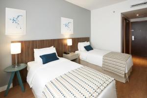 Postel nebo postele na pokoji v ubytování Tulip Inn Itaguai + 32 fotografií