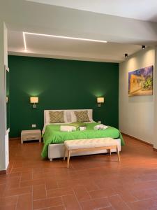 a green bedroom with a bed and a green wall at Villa Zufrò in Vibo Valentia +61 photos