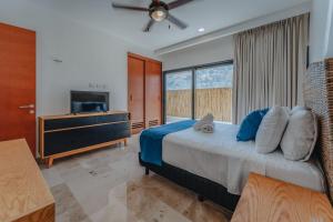 a bedroom with a large bed and a television at Departamento con vista al mar . in Telchac Puerto +49 photos