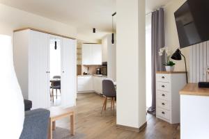 a small apartment with white walls and a dining room at Toscany de LUX samo centrum in Bielsko-Biała