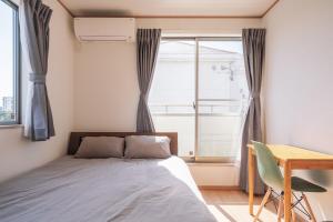 Postel nebo postele na pokoji v ubytování OKINAWA Arena Hotel