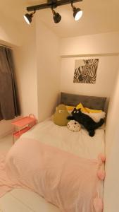 a bedroom with a bed with two stuffed animals on it at Stunning luxury APT with balcony in Tokyo Shinjuku Kabukicho in Tokyo