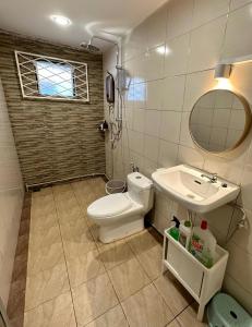 a bathroom with a toilet and a sink at ANG LEE HOLIDAY HOME 2 in Semporna