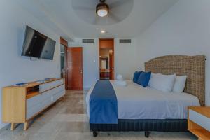 a bedroom with a bed and a flat screen tv at Departamento con vista al mar . in Telchac Puerto