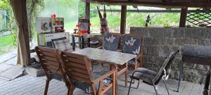 a wooden table and chairs in a kitchen with a stove at U Piškota in Desná