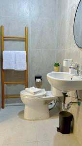 a bathroom with a toilet and a sink at Pollux Habibie Lvl 52 Sea View Studio with Gym,Pool & Netflix in Batam Center