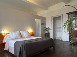 a bedroom with a bed with white sheets and a plant at Oh, le château! in Almayrac +41 photos