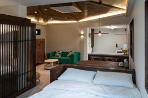 a bedroom with a bed and a living room at Cocoa House in Jeonju