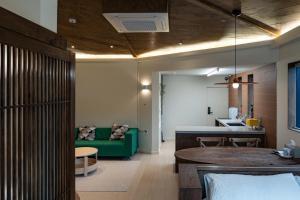 a living room with a green couch and a table at Cocoa House in Jeonju