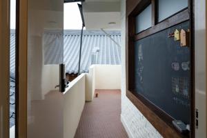 a hallway with a door leading to a balcony at Cocoa House in Jeonju +130 photos