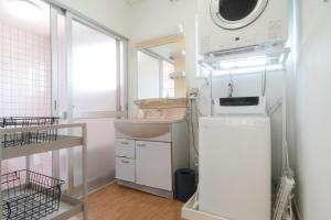 a small kitchen with a sink and a microwave at TIDA Ishigaki in Ishigaki Island +46 photos