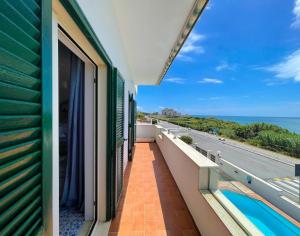 a balcony with a view of the ocean at LA PERLA BIANCA Apartment - Near Train Station and Best Beaches with Amazing Sunsets in Anzio