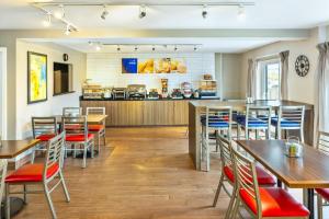 a restaurant with tables and chairs and a counter at Comfort Inn in Charlottetown