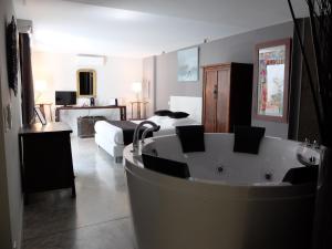 a bathroom with a bath tub and a bedroom at Be Loft B&B Pool & Spa in Avignon +52 photos