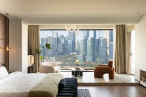 a bedroom with a bed and a view of a city at 重庆大野江景民宿 in Chongqing
