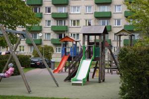 a playground in front of a large building at Boutique Studio Apartment in Ventspils
