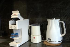 a white blender sitting next to a coffee maker at Boutique Studio Apartment in Ventspils +8 photos