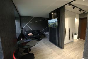 a living room with a couch and a glass table at Boutique Studio Apartment in Ventspils