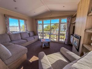 a living room with a couch and a table at Modern 6 Berth Caravan With Free Wifi Nearby Pakefield Beach Ref 68028Cr in Lowestoft