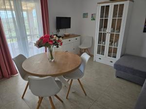 a living room with a table with a vase of flowers at Villa Aura in Milna