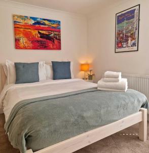 a bedroom with a large bed with a painting on the wall at Upper Rock Brighton – Guest House in Brighton & Hove