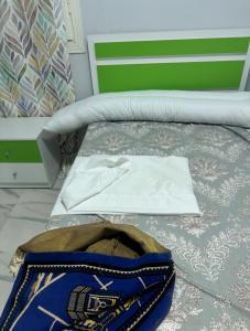 a bed with a hat and a bag on it at Hurghada s 30 in Hurghada