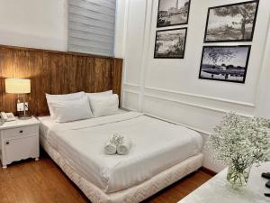 Postel nebo postele na pokoji v ubytování Moc Nha Minh Hotel Da Lat