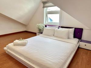 Postel nebo postele na pokoji v ubytování Moc Nha Minh Hotel Da Lat